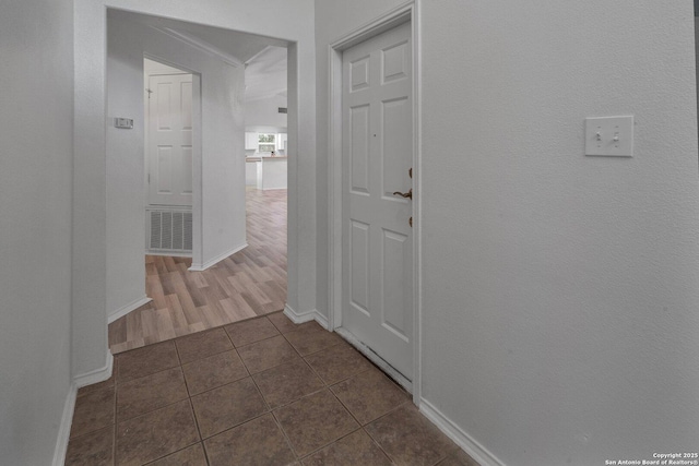 hall with dark tile patterned flooring