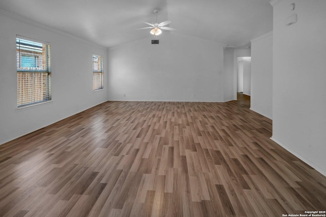 unfurnished living room featuring crown molding, wood-type flooring, ceiling fan, and vaulted ceiling