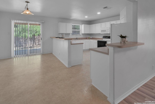 kitchen featuring white cabinets, a kitchen bar, hanging light fixtures, kitchen peninsula, and white appliances