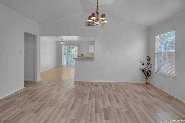 unfurnished living room with crown molding, a wealth of natural light, and light hardwood / wood-style floors