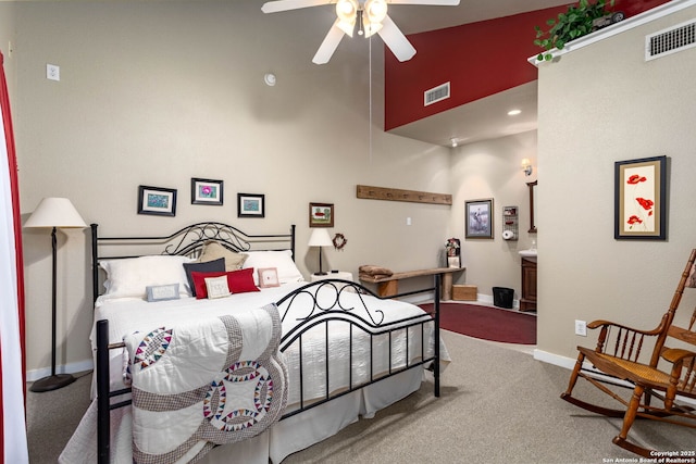 carpeted bedroom with ceiling fan and high vaulted ceiling