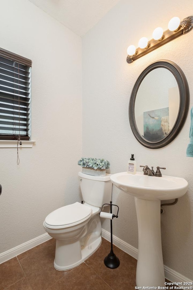 bathroom with sink, tile patterned floors, and toilet