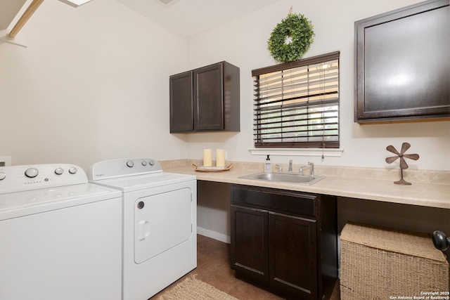 washroom with sink, cabinets, and washer and dryer