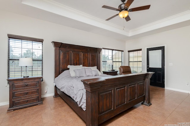 tiled bedroom with a tray ceiling, ornamental molding, and ceiling fan