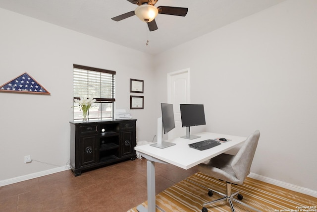 office featuring ceiling fan and dark tile patterned floors