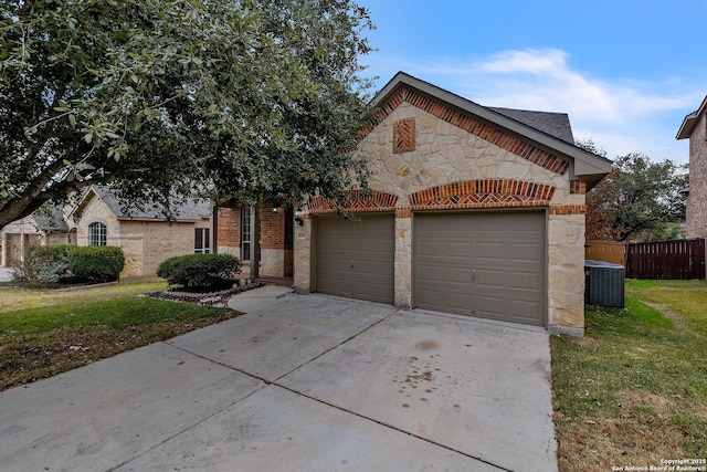 view of front of home featuring a garage, a front lawn, and central air condition unit