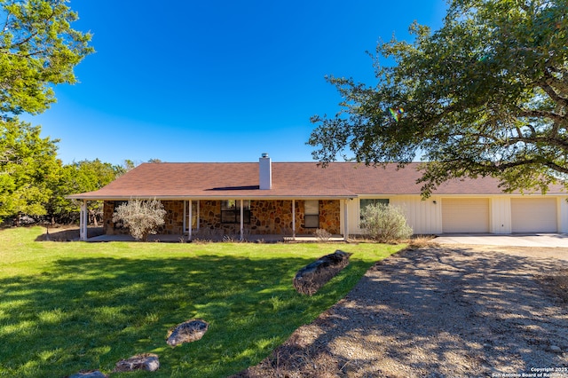 single story home featuring a garage and a front yard