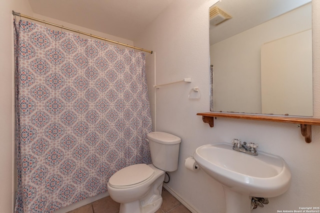 bathroom featuring tile patterned flooring, sink, a shower with curtain, and toilet