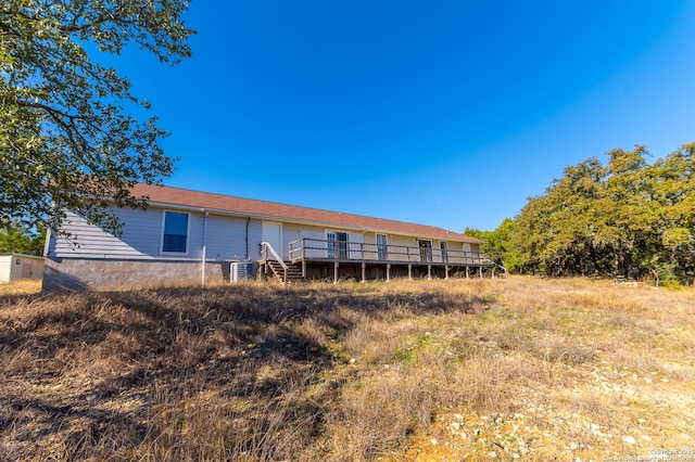 rear view of house featuring a wooden deck