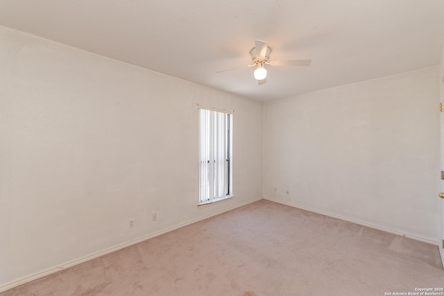 spare room featuring light carpet and ceiling fan