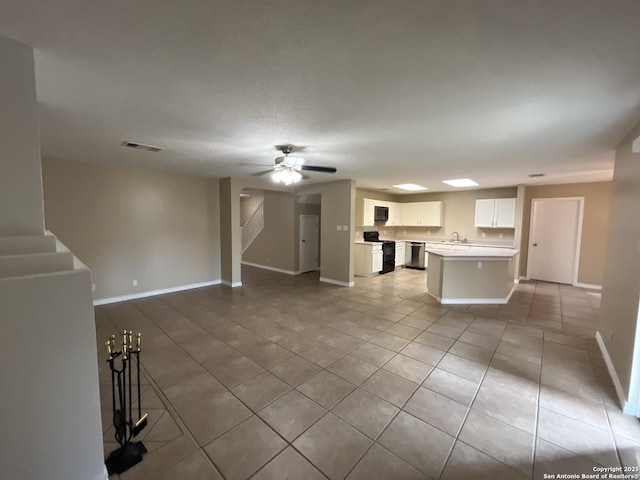 kitchen with light tile patterned floors, ceiling fan, white cabinetry, black range with electric stovetop, and stainless steel dishwasher