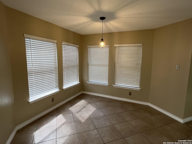 unfurnished dining area with a healthy amount of sunlight and tile patterned flooring