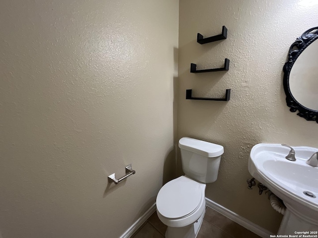 bathroom featuring tile patterned flooring, sink, and toilet