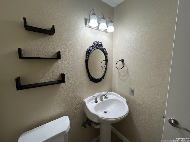 bathroom featuring toilet and sink