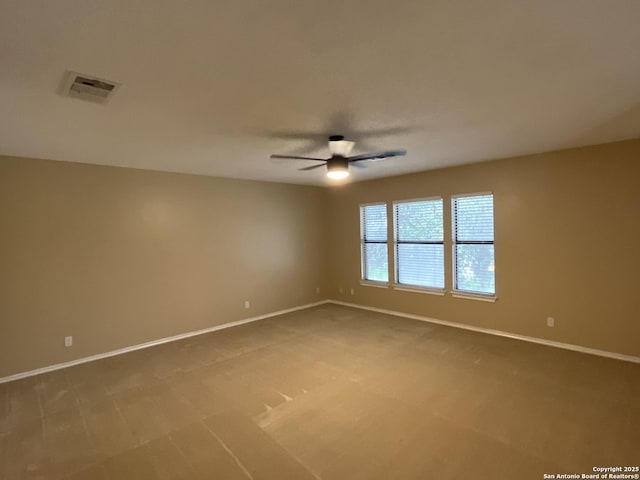 carpeted spare room featuring ceiling fan