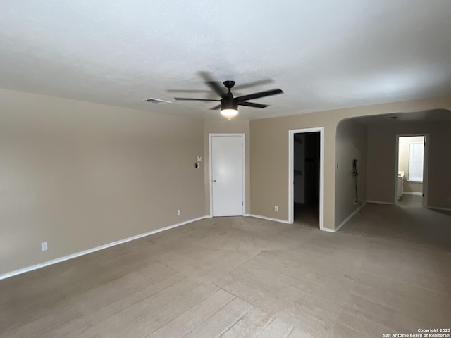 unfurnished room featuring light carpet and ceiling fan