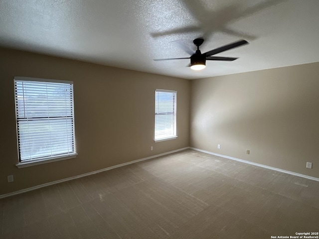 spare room with ceiling fan, carpet, and a textured ceiling