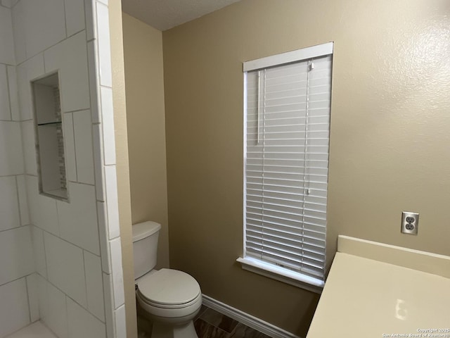 bathroom with hardwood / wood-style floors and toilet