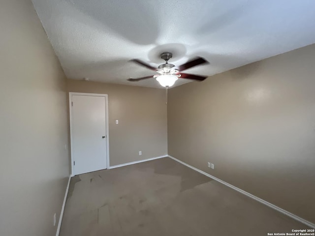 empty room featuring ceiling fan, carpet floors, and a textured ceiling