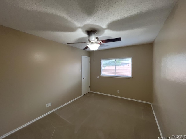 carpeted empty room with ceiling fan and a textured ceiling