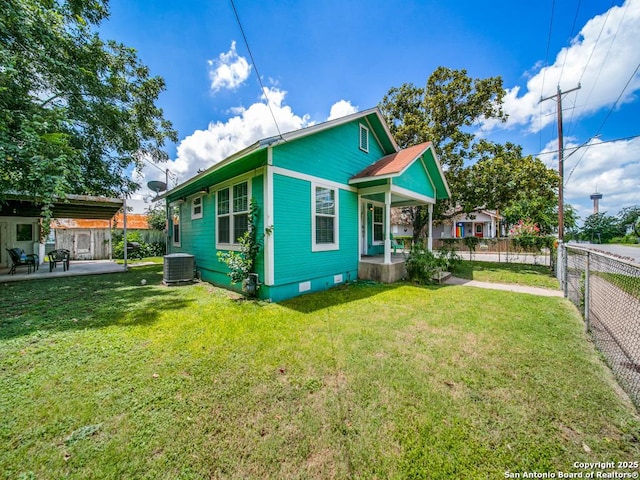 view of front of house featuring central AC, a front yard, and a patio area