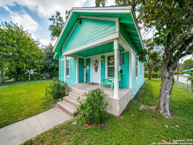 bungalow-style house with a porch and a front yard