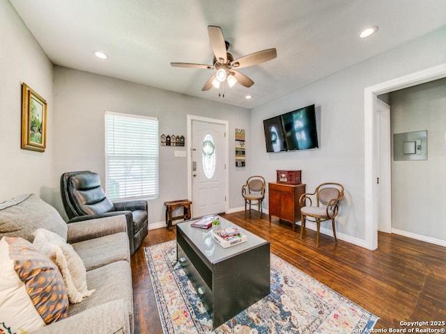 living room featuring dark hardwood / wood-style floors and ceiling fan