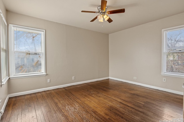 spare room with dark hardwood / wood-style floors and ceiling fan