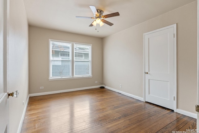 unfurnished room with hardwood / wood-style flooring and ceiling fan