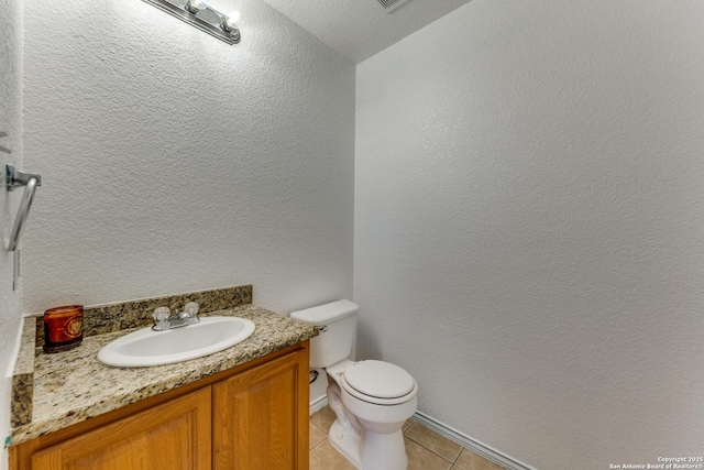 bathroom featuring tile patterned floors, vanity, and toilet