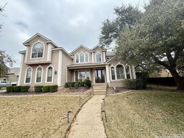 view of front of home featuring covered porch and a front yard