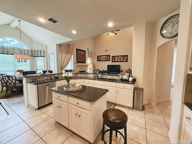 kitchen with pendant lighting, white cabinets, a kitchen island, stainless steel dishwasher, and kitchen peninsula