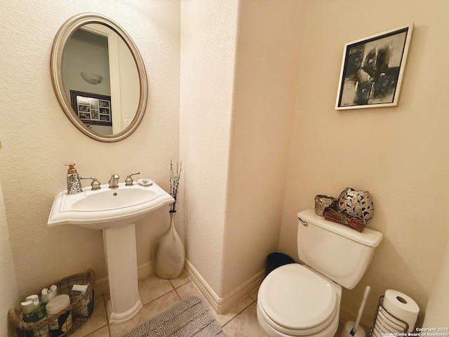 bathroom with tile patterned floors and toilet