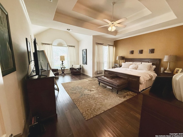 bedroom featuring crown molding, dark wood-type flooring, and a raised ceiling