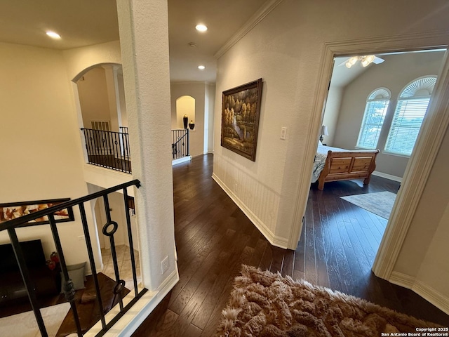 corridor with crown molding and dark wood-type flooring