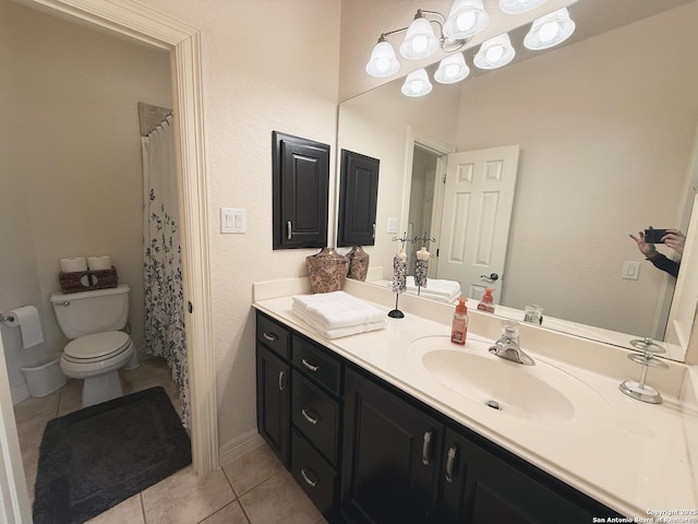 bathroom featuring tile patterned flooring, vanity, and toilet