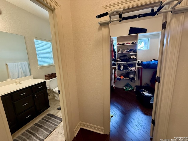 bathroom featuring hardwood / wood-style flooring, vanity, and toilet