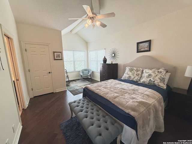 bedroom with ceiling fan, dark hardwood / wood-style floors, a textured ceiling, and vaulted ceiling with beams