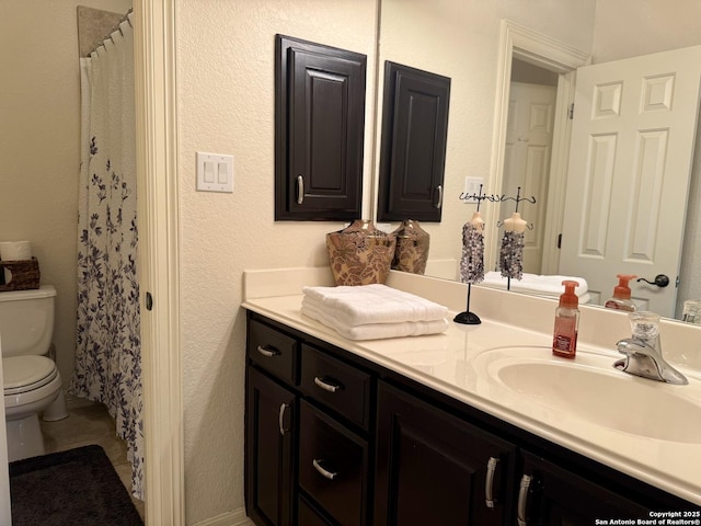 bathroom with tile patterned floors, vanity, toilet, and a shower with shower curtain