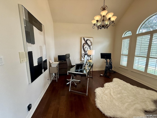 exercise area featuring dark hardwood / wood-style flooring, vaulted ceiling, and an inviting chandelier