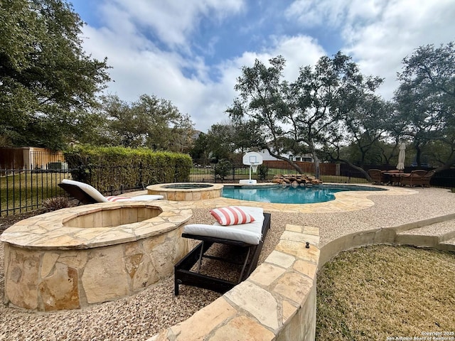 view of swimming pool with an in ground hot tub, a fire pit, and a patio area