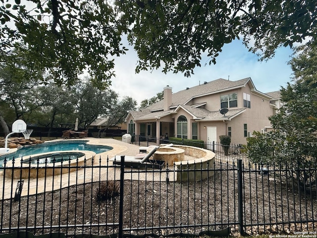 view of pool featuring a patio and an in ground hot tub