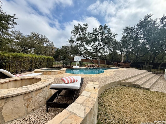 view of pool with an in ground hot tub and a patio area