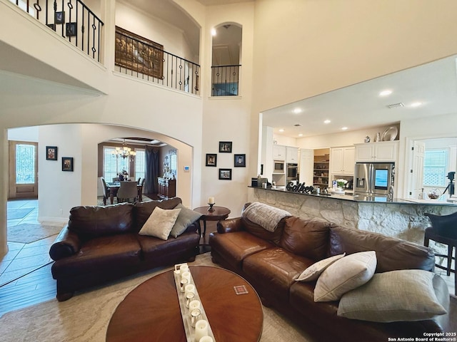 living room featuring a chandelier and a high ceiling