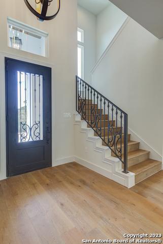 foyer entrance with hardwood / wood-style floors and a high ceiling