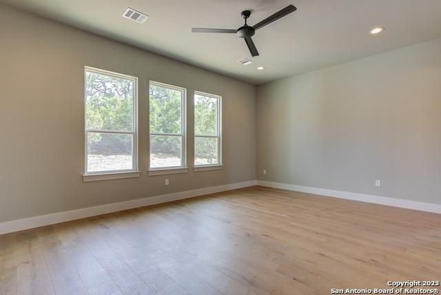 empty room featuring ceiling fan and light hardwood / wood-style floors