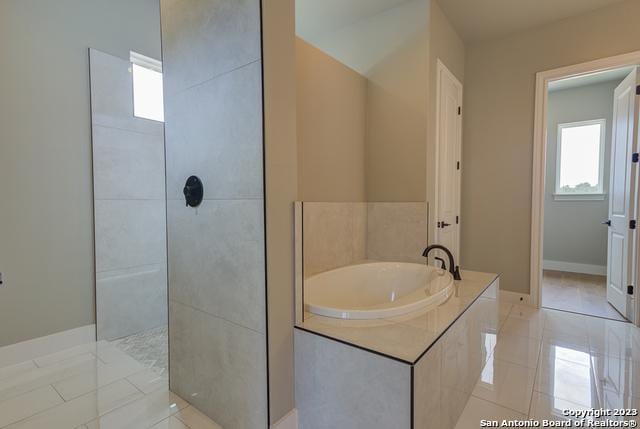 bathroom featuring tile patterned floors and shower with separate bathtub