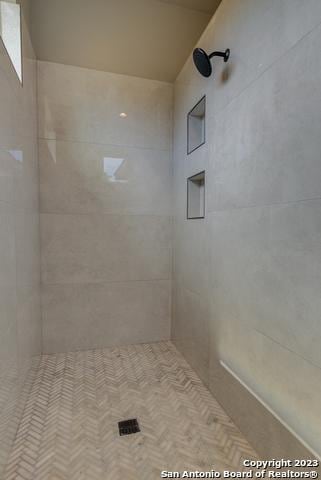 bathroom with tiled shower