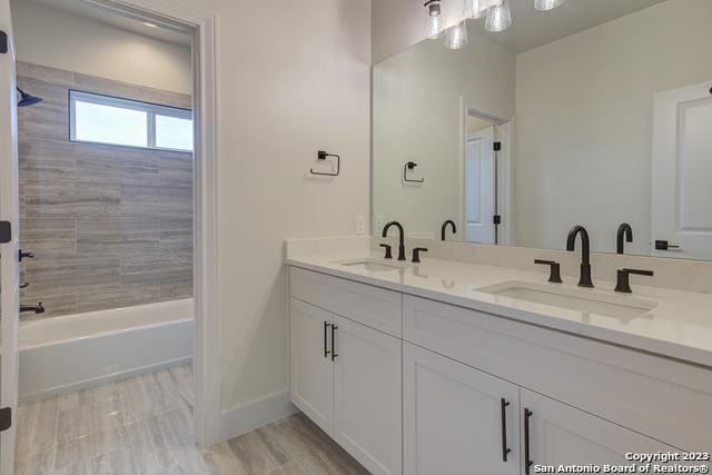 bathroom with vanity and tiled shower / bath combo