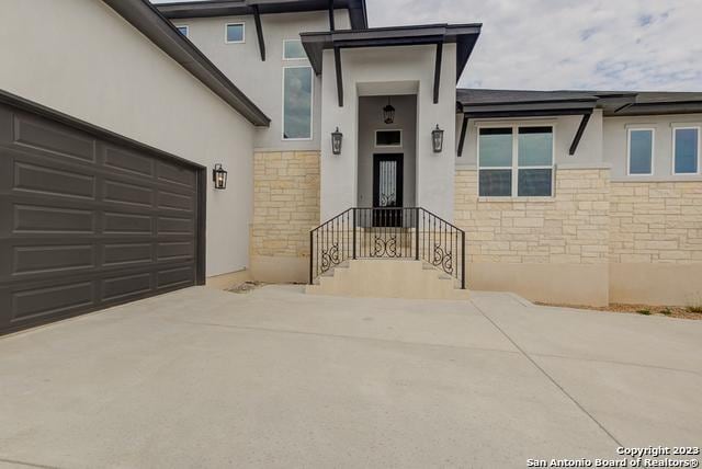 view of exterior entry featuring a garage